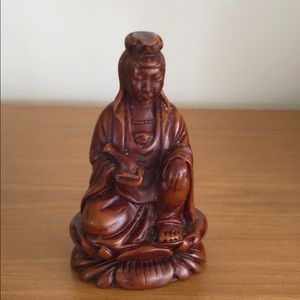 Kneeling brown Buddha approx 4in tall 3in wide.